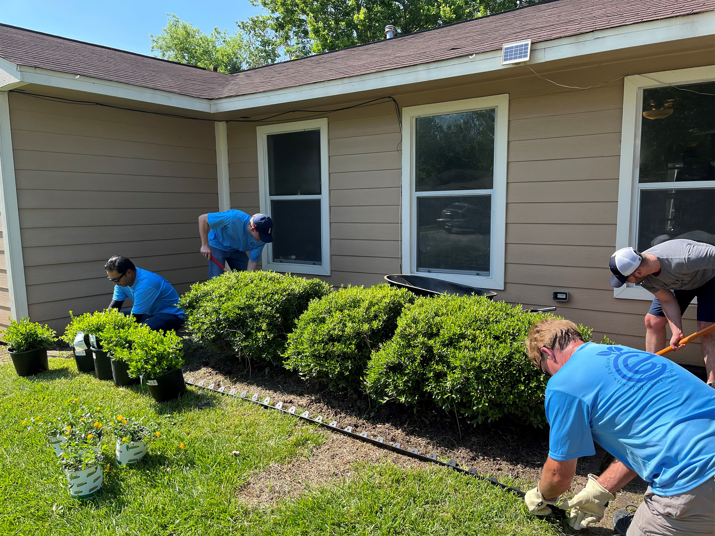 EnCap employees work on landscaping the home’s front yard.