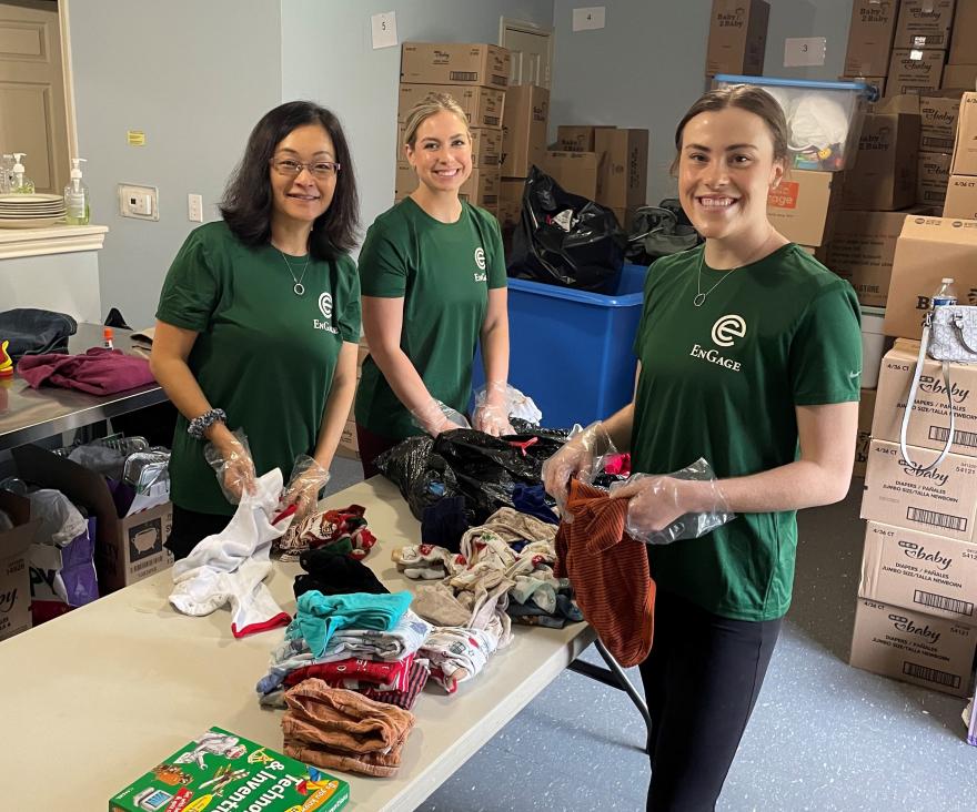 Jane Gu (L), Catharine Mixon (M) and Natalie Rathjen (R) sort through clothing donations.