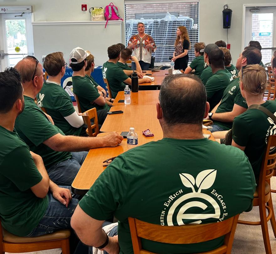 After completing volunteer work, employees listen to the impactful stories of Santa Maria Hostel residents. 