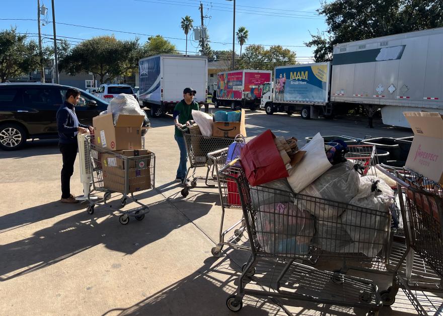 Adil Rajabali (L) and Shamil Zuberi (R) receive donations from the community at MAM’s donation center.